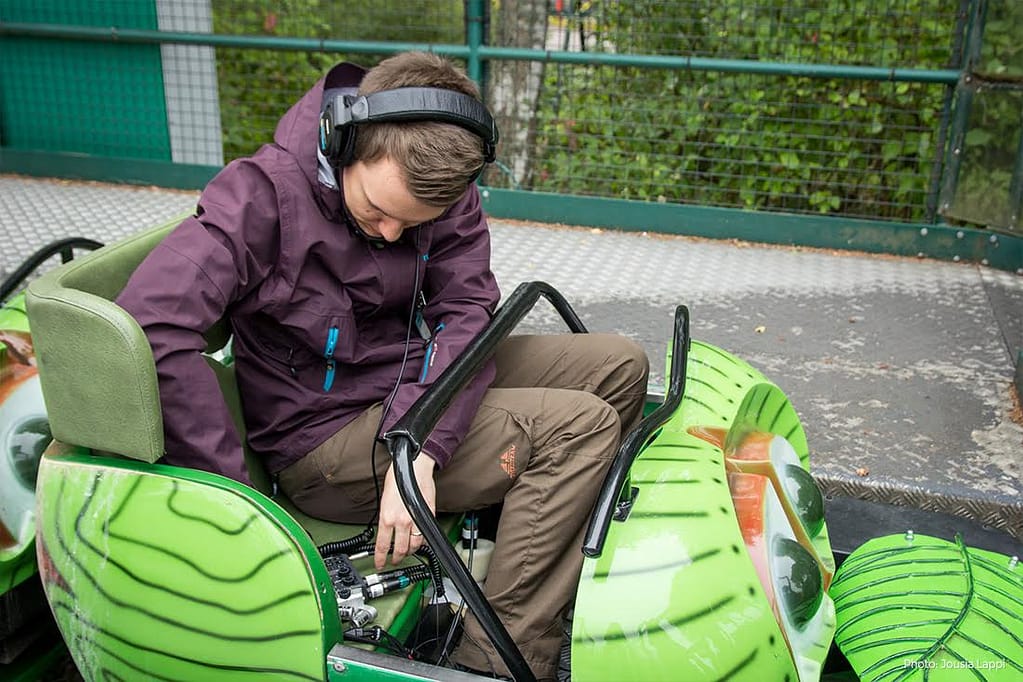 Pyry sets up recording equipment in a kids' roller coaster