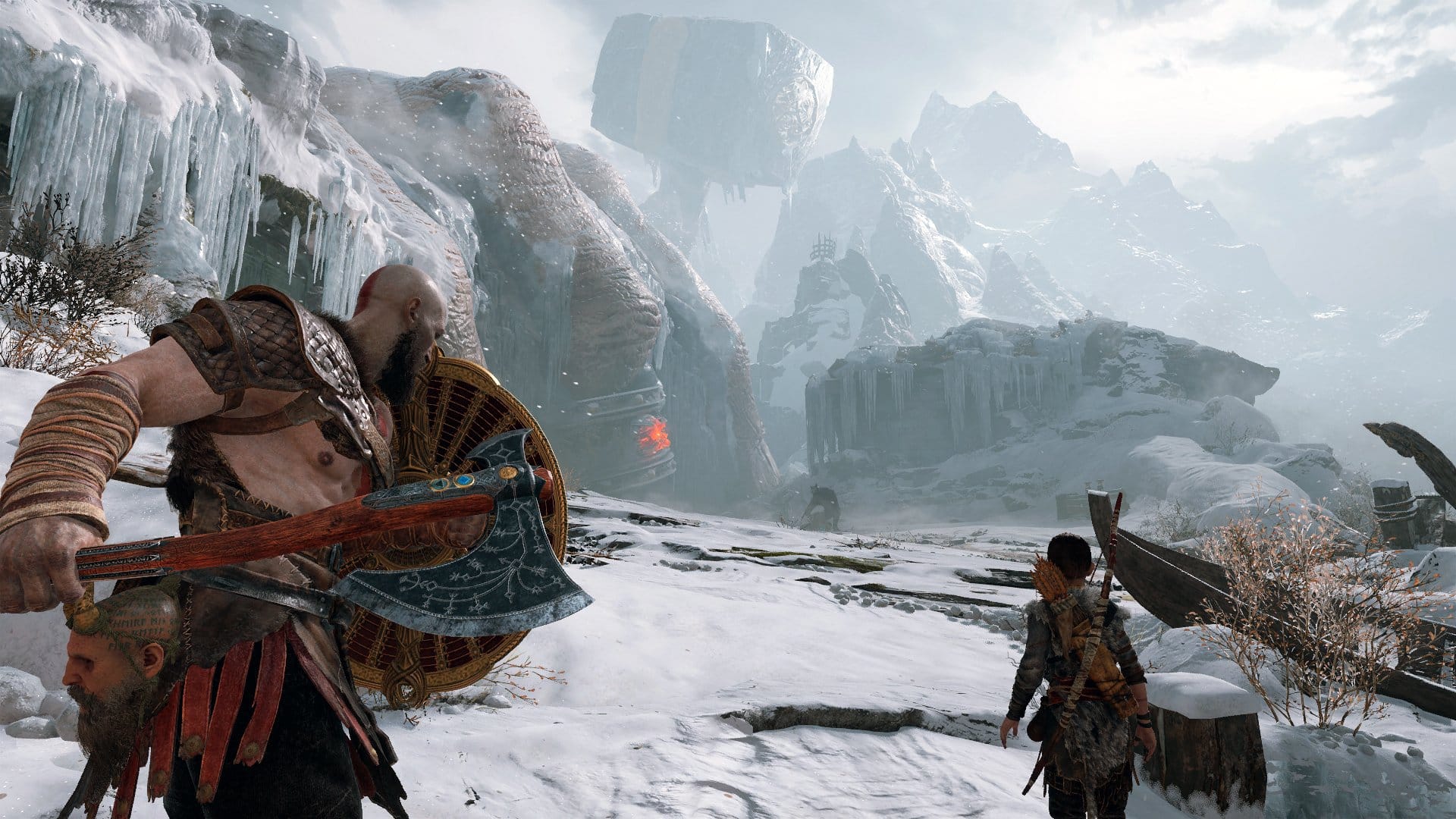 Kratos and his son traverse a snowy mountain range