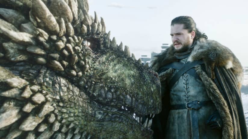 Rheagal the dragon nuzzles Jon Snow.
