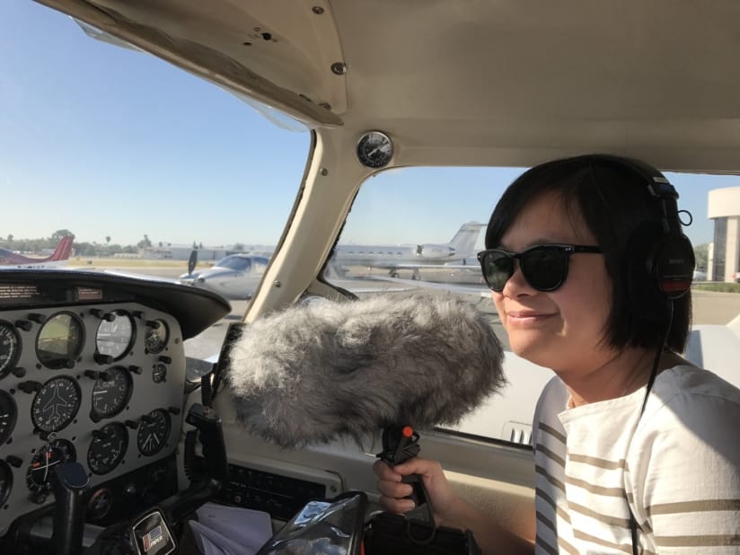 Ai-Ling Lee sits in the cockpit with a boom mic.