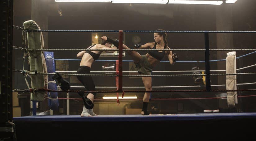 Lara lands a kick as she spars in the ring.