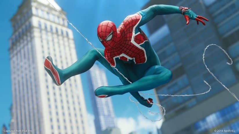 Spider-Man maneuvers his web as he swings near the Empire State Building