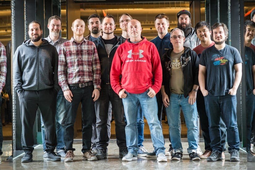 A group of 12 men stand for a picture at Ubisoft.