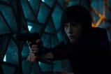 Scarlett Johansson points a handgun