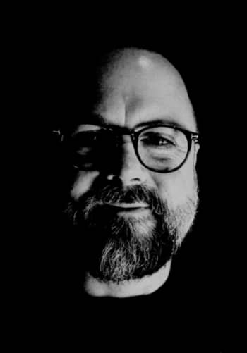 A man with a beard and glasses.