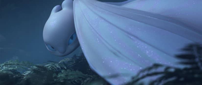 A smooth white dragon with blue eyes peers from beneath her wing.