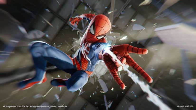 Spider-Man shoots his web as shattered glass flies past him